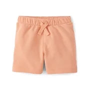 A pair of peach-colored cotton shorts with an elastic waistband and drawstring, shown flat on a white background.