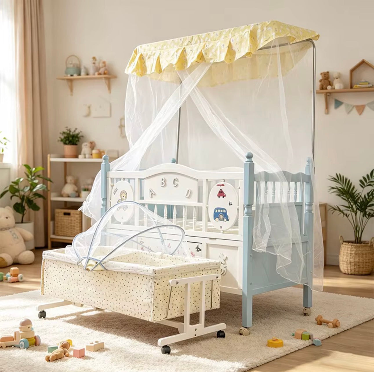 Baby Wooden Cot with a hanging Bassinet Crib with Mosquito Net-Beks Ghana
A white and light blue baby crib with a yellow canopy and white tulle mosquito net, shown next to a matching bassinet in a styled nursery room.